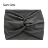 A dark gray fabric headband is tightly cross-knotted and displayed flat.