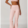 A woman models a pink 3-piece yoga sports set consisting of a cropped top and high-waisted pants.