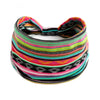 A colorful striped bohemian cotton stretch headband worn around the head.