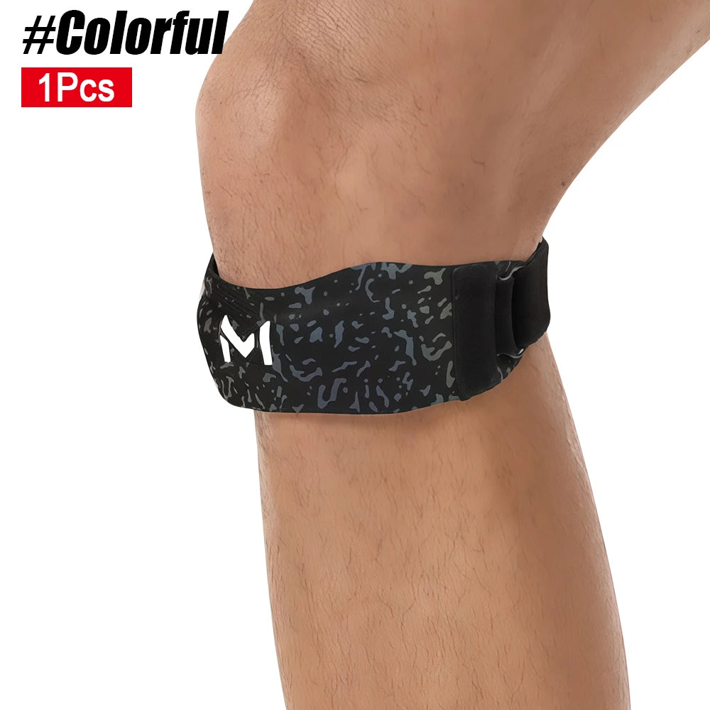 Black knee brace with a mottled gray pattern worn on the lower leg.