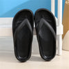 A pair of black comfort platform flip flops resting on a white surface.