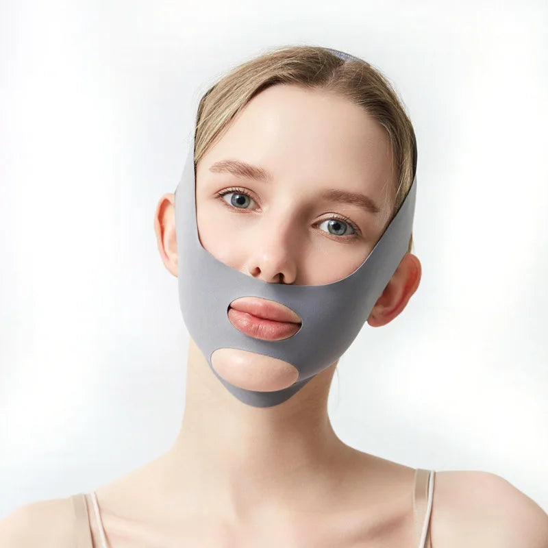 A woman wearing a gray face slimming lifting strap designed for double chin treatment.