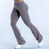 A person wearing seamless gray flared yoga leggings and white sneakers is shown in a side profile.