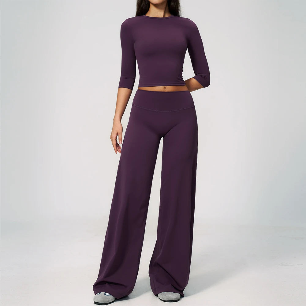 A woman wearing a matching purple yoga and fitness leggings set.