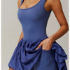 Model in a royal blue performance tennis dress for activewear.