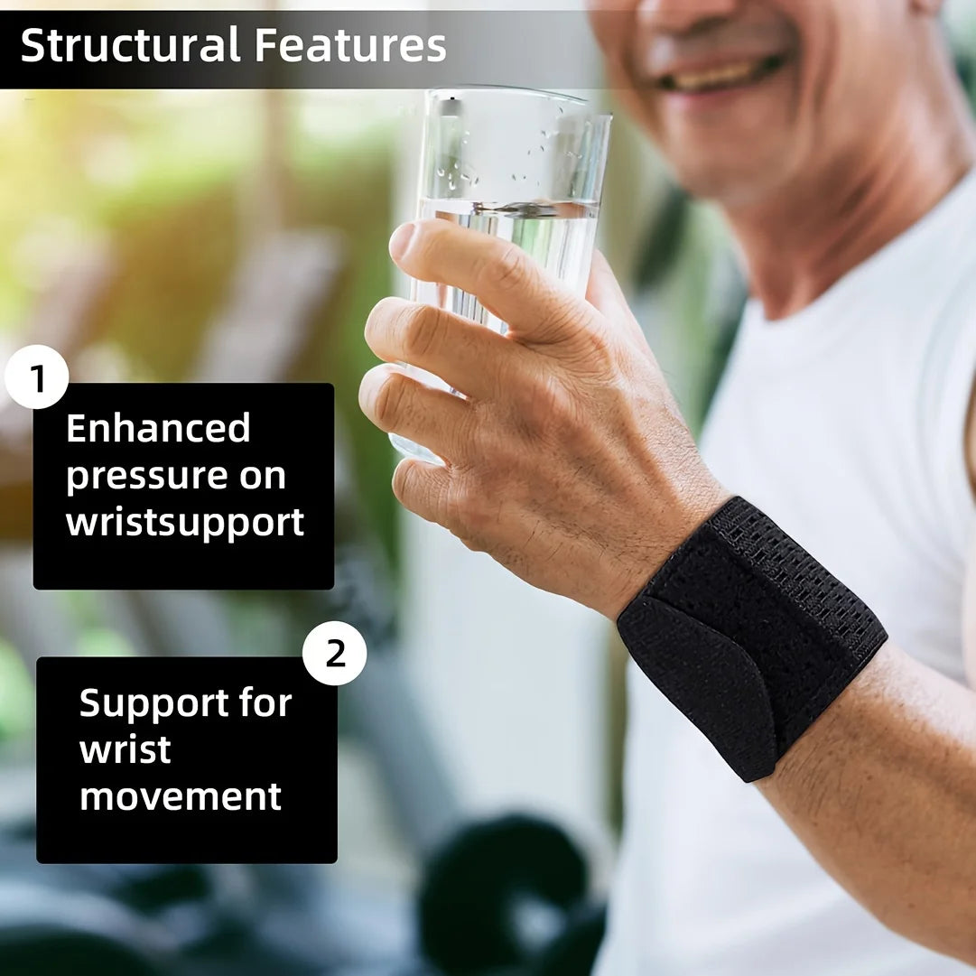 A man is holding a glass of water while wearing a black wrist support strap on his wrist.
