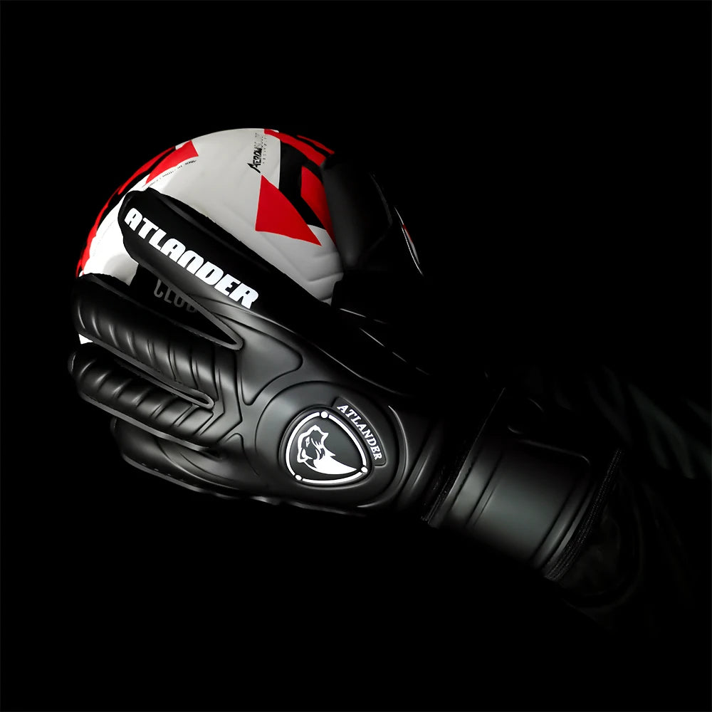 Black latex goalkeeper gloves with red and white accents shown in a close-up view.