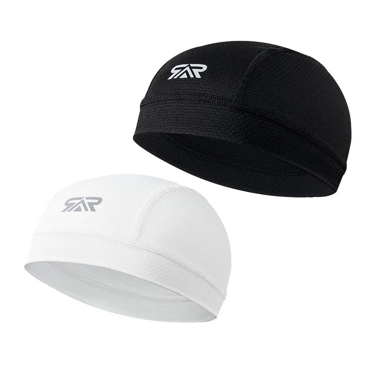 A black cycling cap with a silver logo and a white version of the same cap.