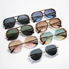 A collection of vintage oversized designer sunglasses in various shades of brown, black, and green.