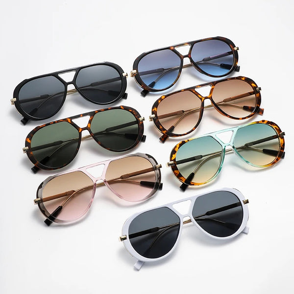 A collection of vintage oversized designer sunglasses in various shades of brown, black, and green.