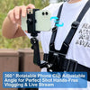 A hand holds a smartphone attached to an adjustable chest strap kit for hands-free vlogging or live streaming.