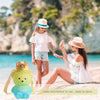 A woman is holding a portable bear water bottle with a straw and strap on a beach.