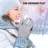 A woman wearing insulated winter gloves is holding a cup outdoors in the snow.