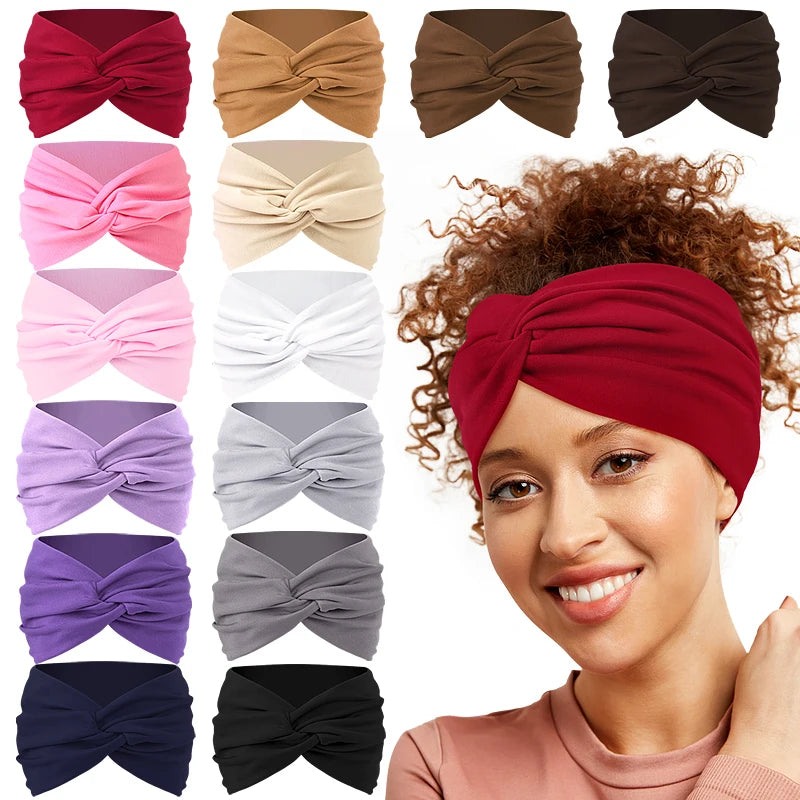 A woman models a red twisted criss cross elastic headband for yoga and sports.