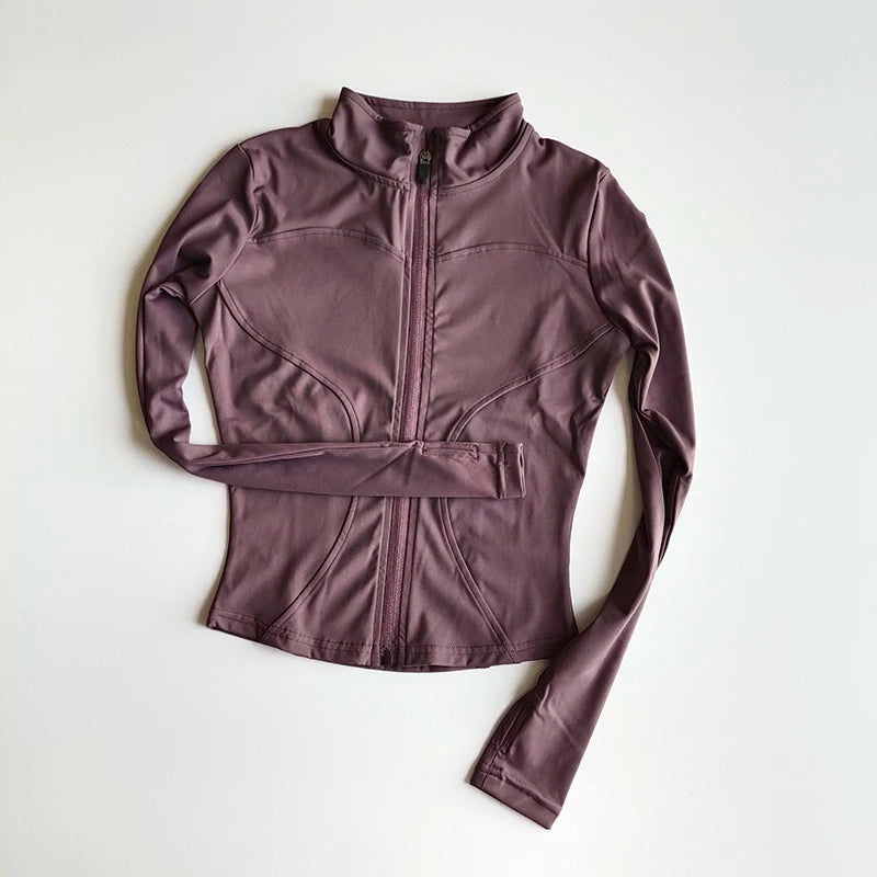 A mauve, long-sleeved athletic jacket with a high collar and zippered front, displayed flat.