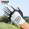 A close-up of a white and black PGA Pro Golf Master glove being worn on a hand in an outdoor golf setting.