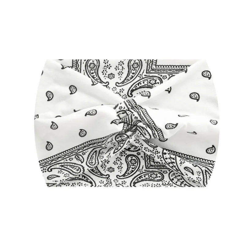 White boho printed wide knotted headband with paisley and floral patterns