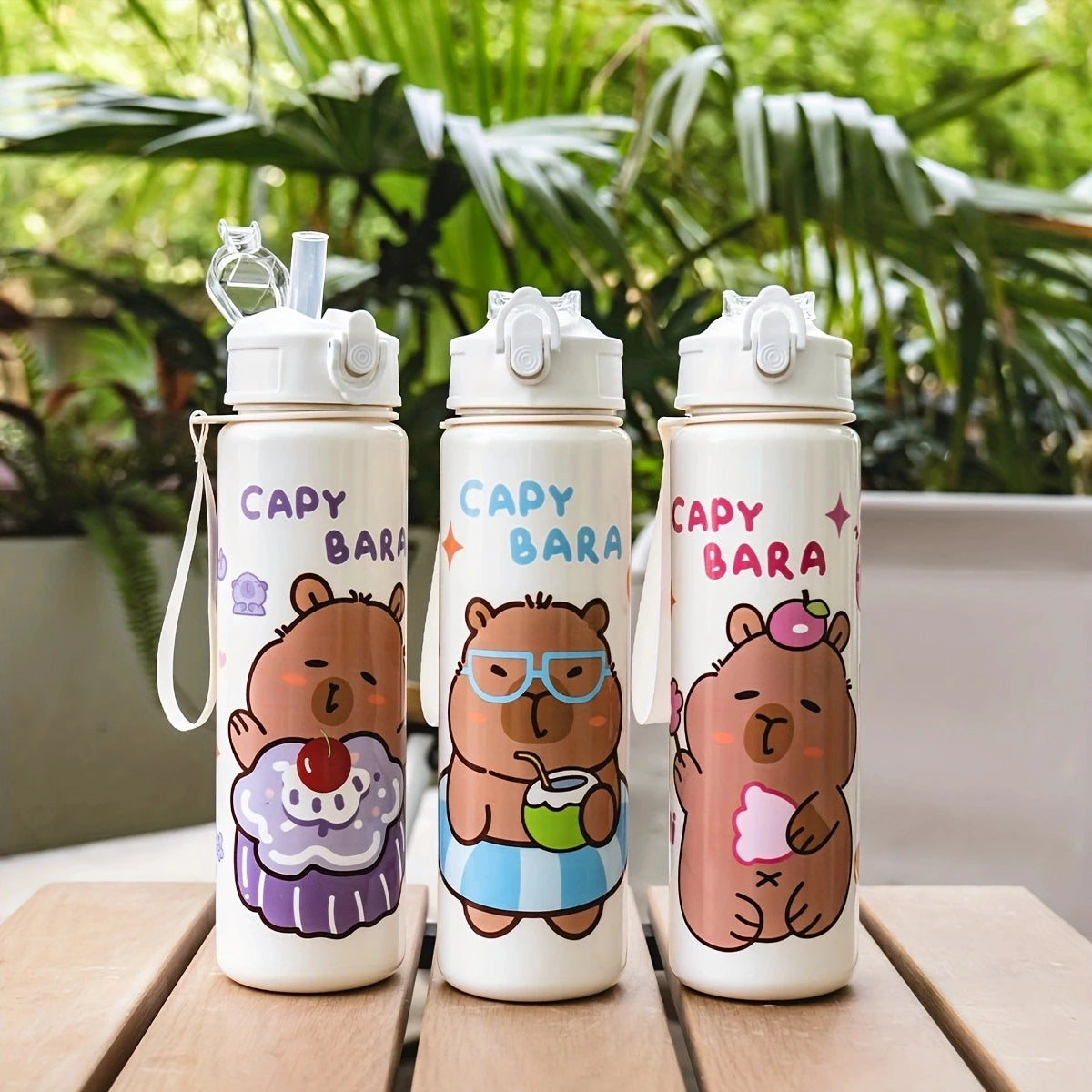 Three cartoon drinking water bottles featuring bears with glasses and straws set against a green foliage background