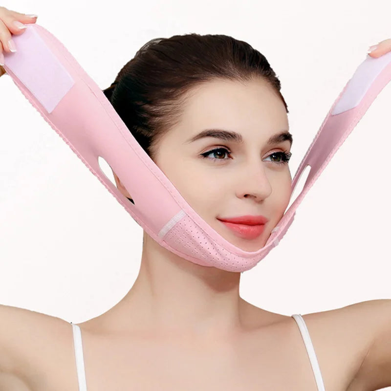 A woman is wearing a pink face slimming lifting strap designed for double chin treatment.