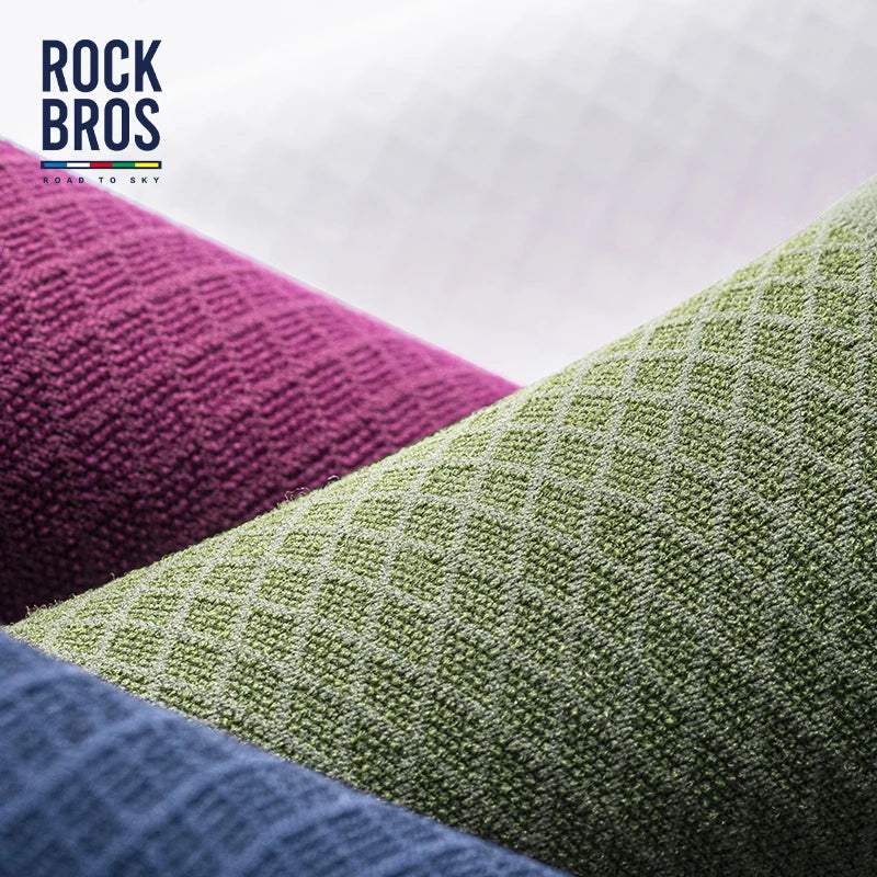 A close-up of high elastic cycling and hiking socks in shades of purple, green, and blue fabric.