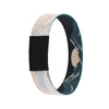 A wristband bracelet featuring a camouflage pattern with light beige and dark green colors.