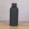 A matte dark gray double-layer vacuum thermos cup with a black cap sitting on a wooden surface.