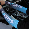 A person wearing a blue dotted sports sleeve on their arm while driving a car.