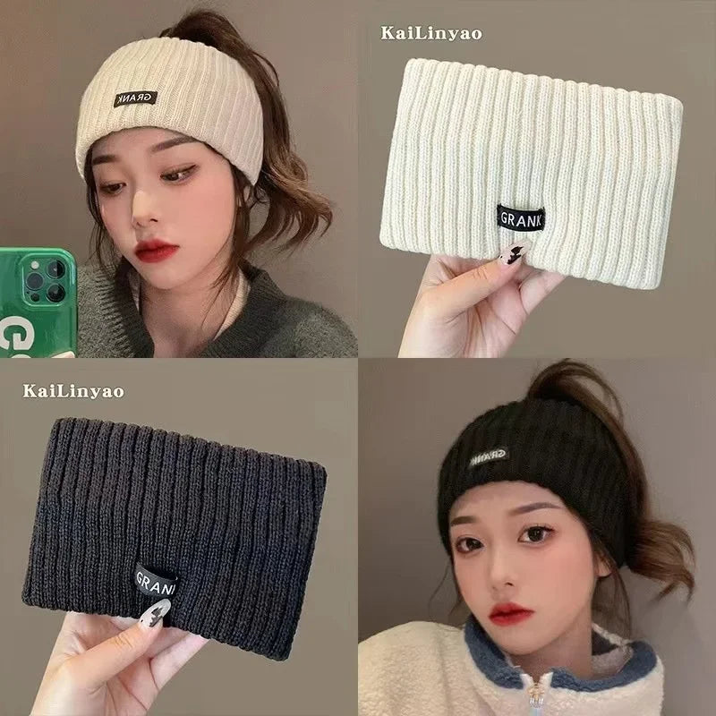 A close-up of a knitted headband worn by a woman, shown in light beige and dark gray colors.