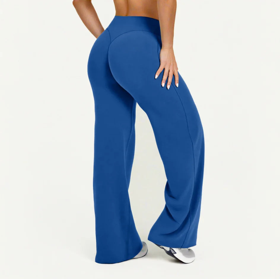 A model wearing royal blue high-waist yoga pants, shown from the side.