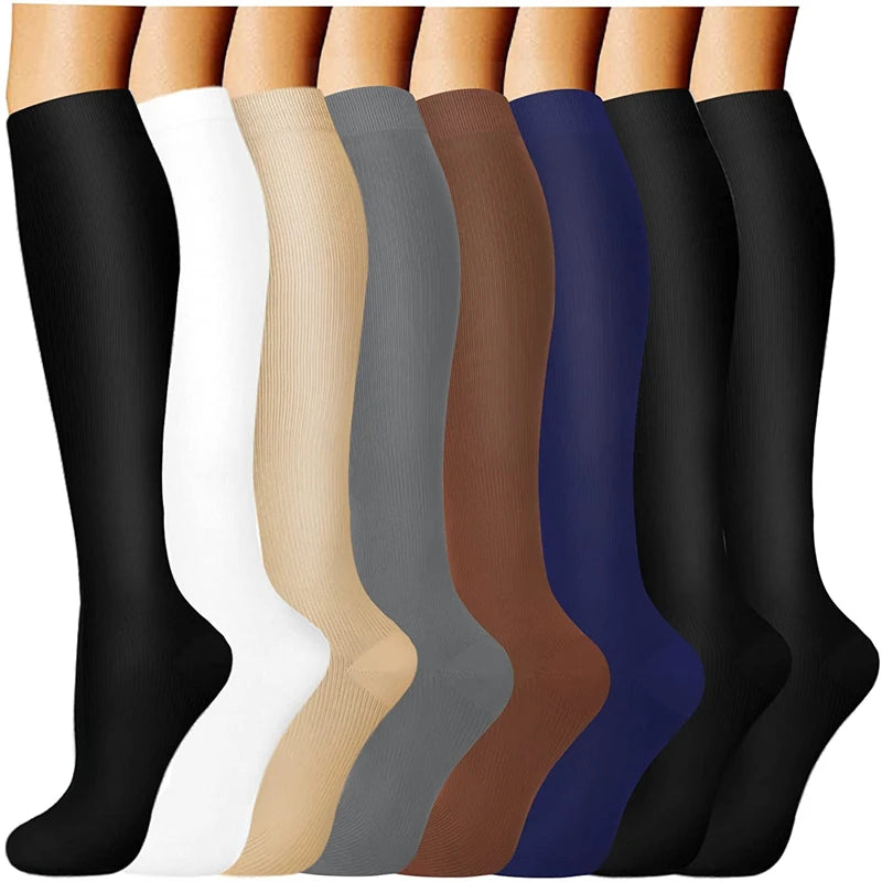 A row of compression socks in various colors, including black, white, beige, gray, brown, and blue.