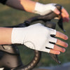 A hand wearing a white half-finger cycling glove is adjusting the fingers of a black bicycle handlebar.
