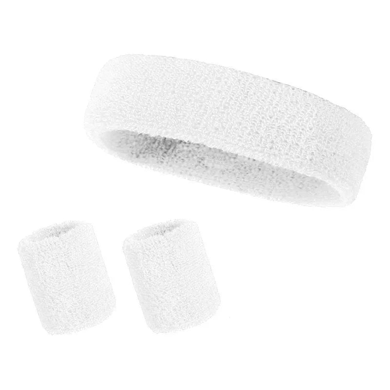 A set of three white athletic sweatbands or hairbands rolled into cylindrical shapes.