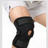 A black adjustable knee pad with dual stabilizers is shown on a person's leg for joint support.