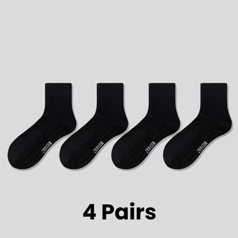 Four pairs of black breathable sports performance socks laid out flat.