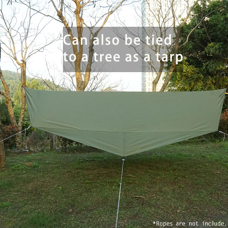 A large, light green tarp is stretched between two points in an outdoor grassy area.