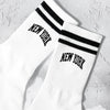 White crew socks with black stripes and New York lettering