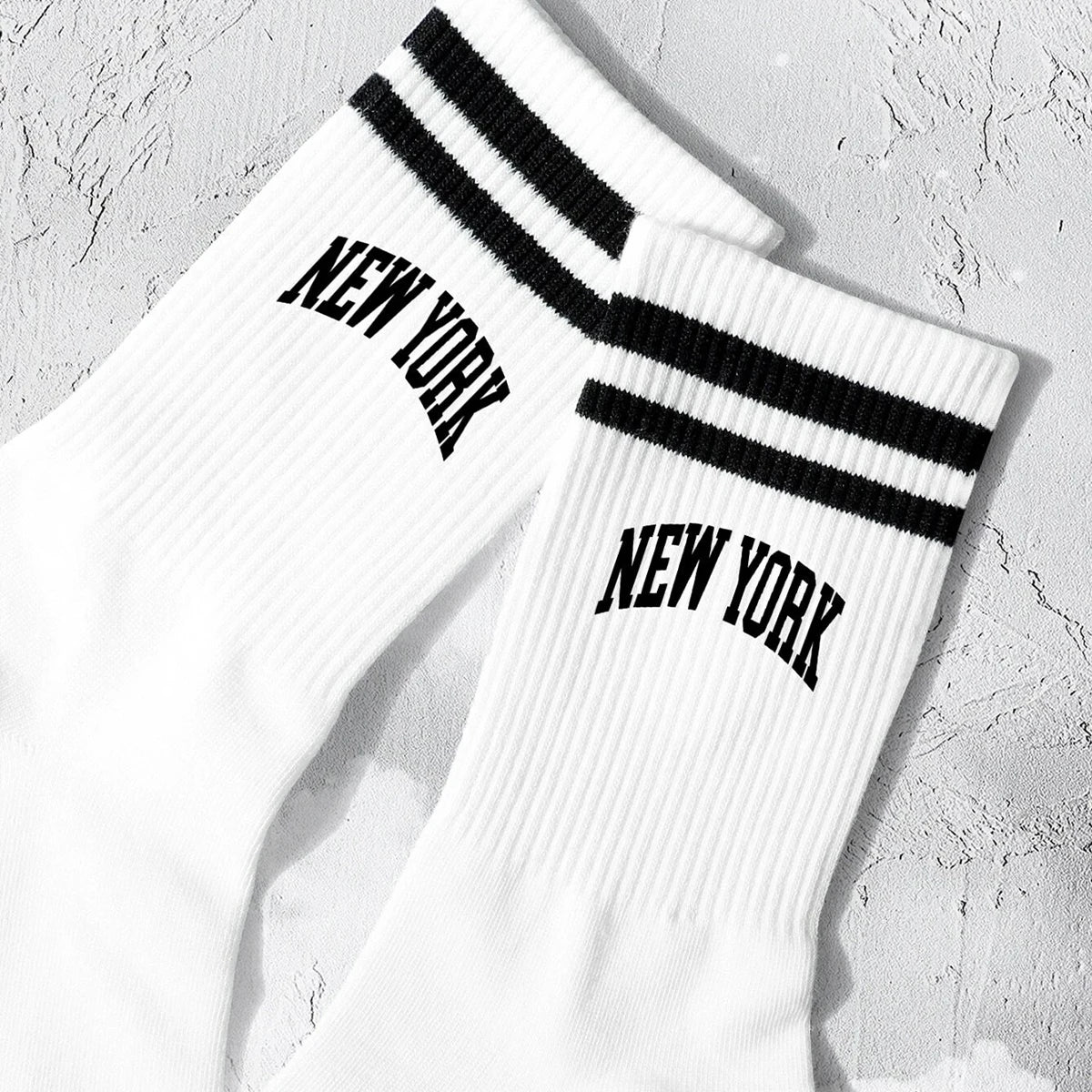 White crew socks with black stripes and New York lettering