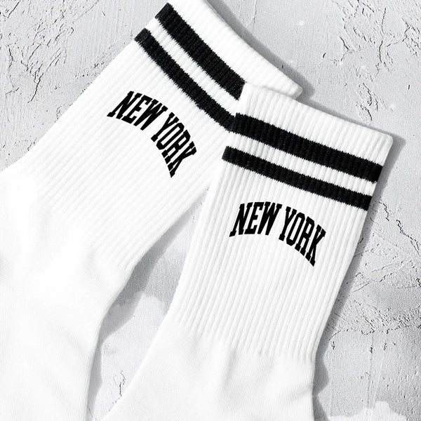 White crew socks with black stripes and New York lettering