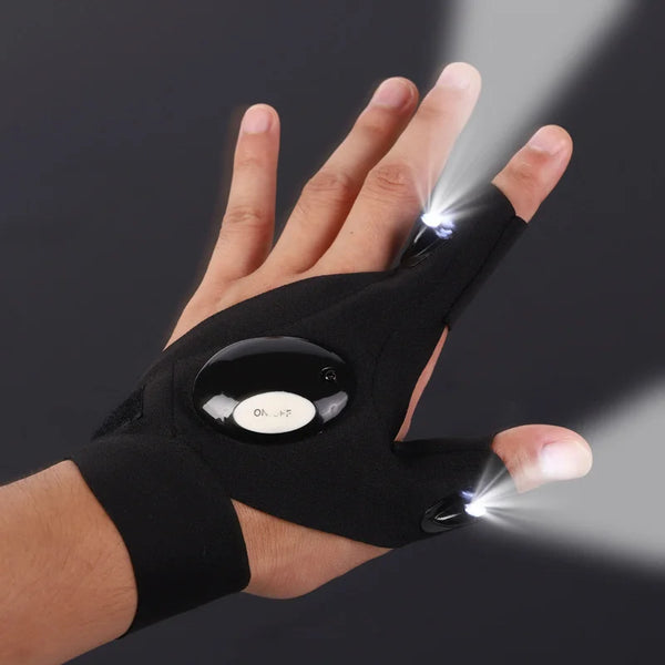 A hand wearing tactical gloves with LED flashlights activated, illuminating the surrounding dark background.