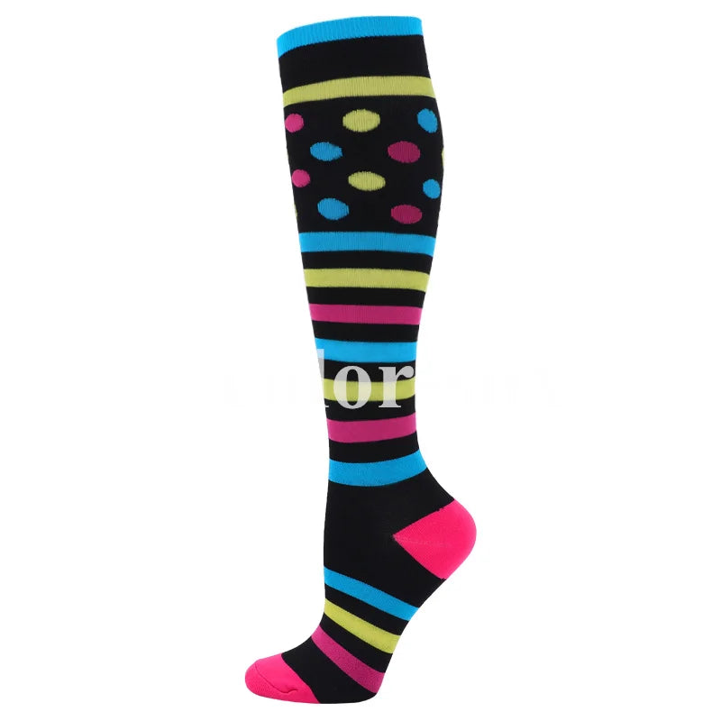 A pair of medical grade compression socks featuring horizontal stripes in black, pink, blue, and yellow with colorful polka d