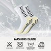 A pair of white and black patterned silicone grip socks shown with a washing guide.