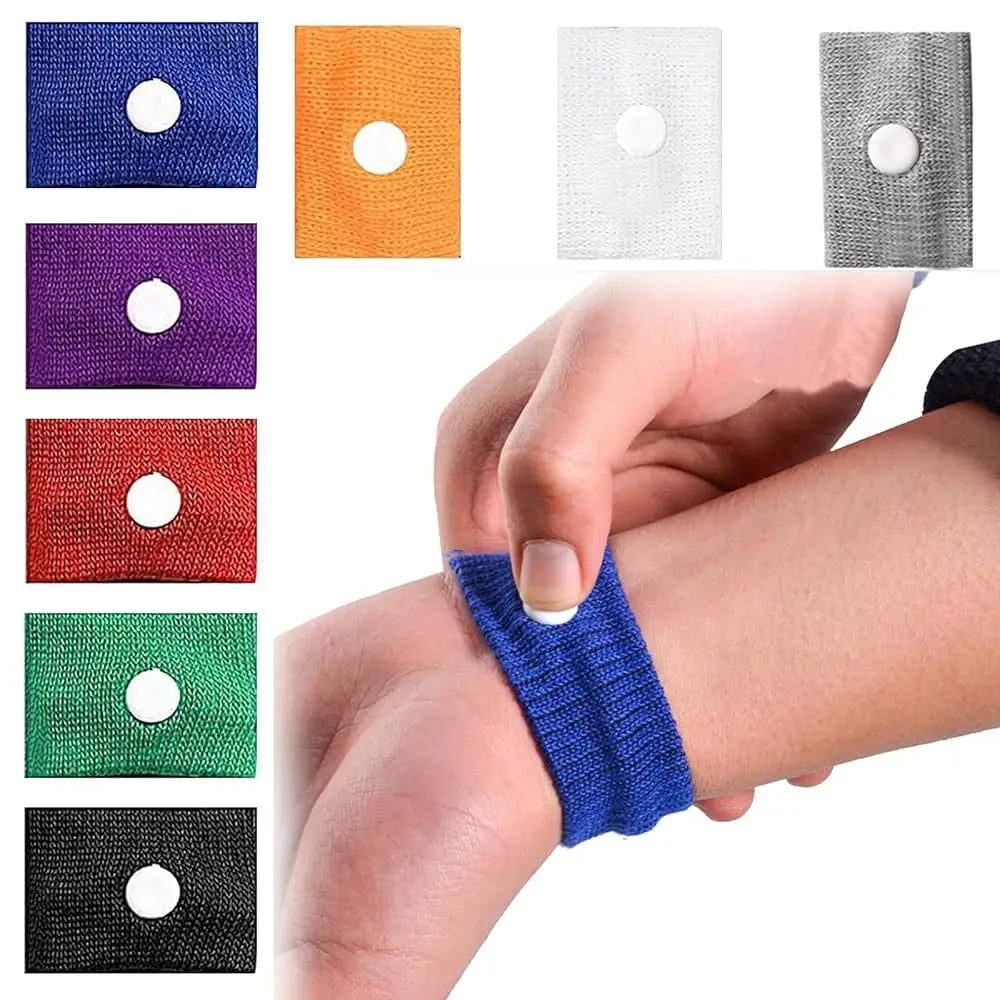 A collection of various colored anti-nausea wristbands shown on a hand and arm.