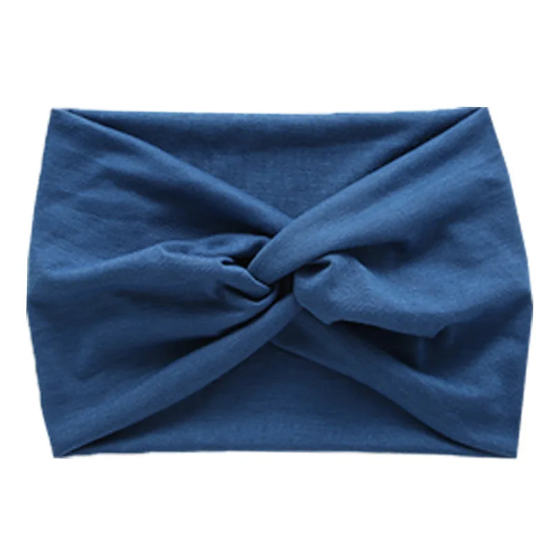 A navy blue women's elastic sports headband tied in a knot.
