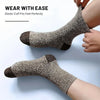 A close-up of a brown and black patterned elastic cuff sock being worn on a foot.