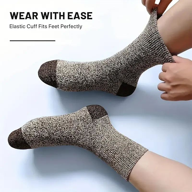 A close-up of a brown and black patterned elastic cuff sock being worn on a foot.