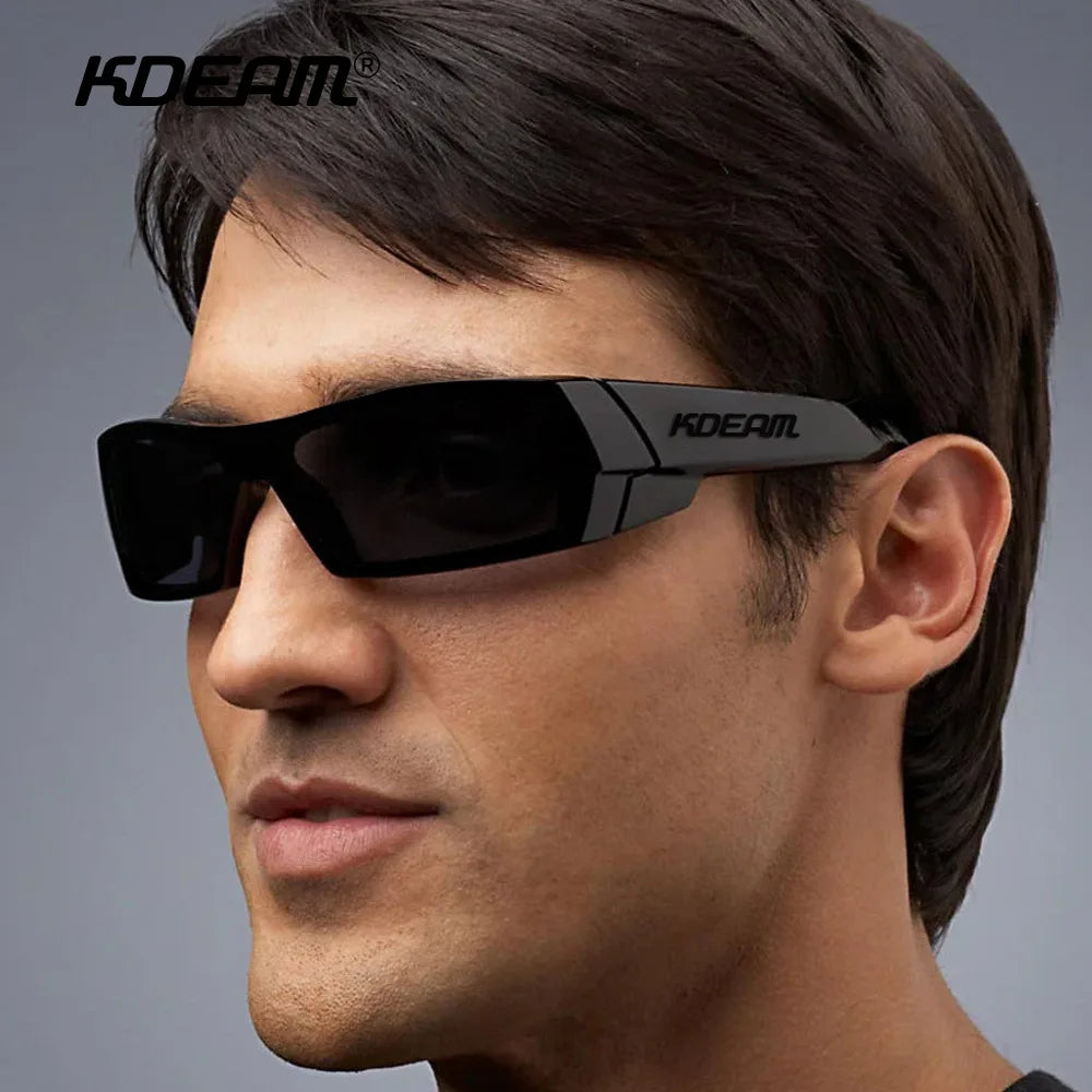 A man wearing black KDEAM polarized sports sunglasses against a gray background.