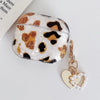 A clear protective case for AirPods Pro featuring a leopard print design with gold and black spots, attached to a gold chain 