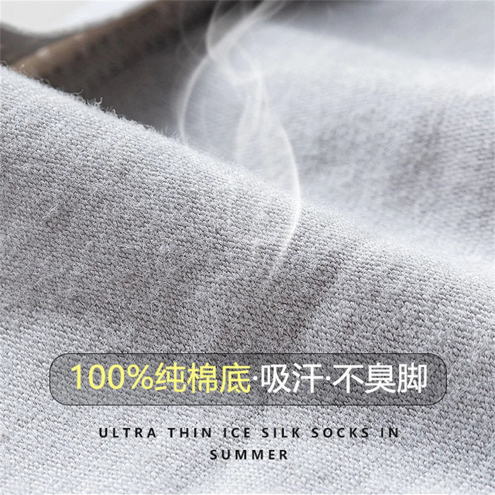 Close-up of light gray ultra-thin ice silk socks being displayed, showing a soft texture and steam.