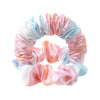 A headband made of pink and blue satin fabric with gathered folds.