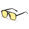 Un par de gafas de sol cuadradas negras y ligeras con lentes tintados en amarillo